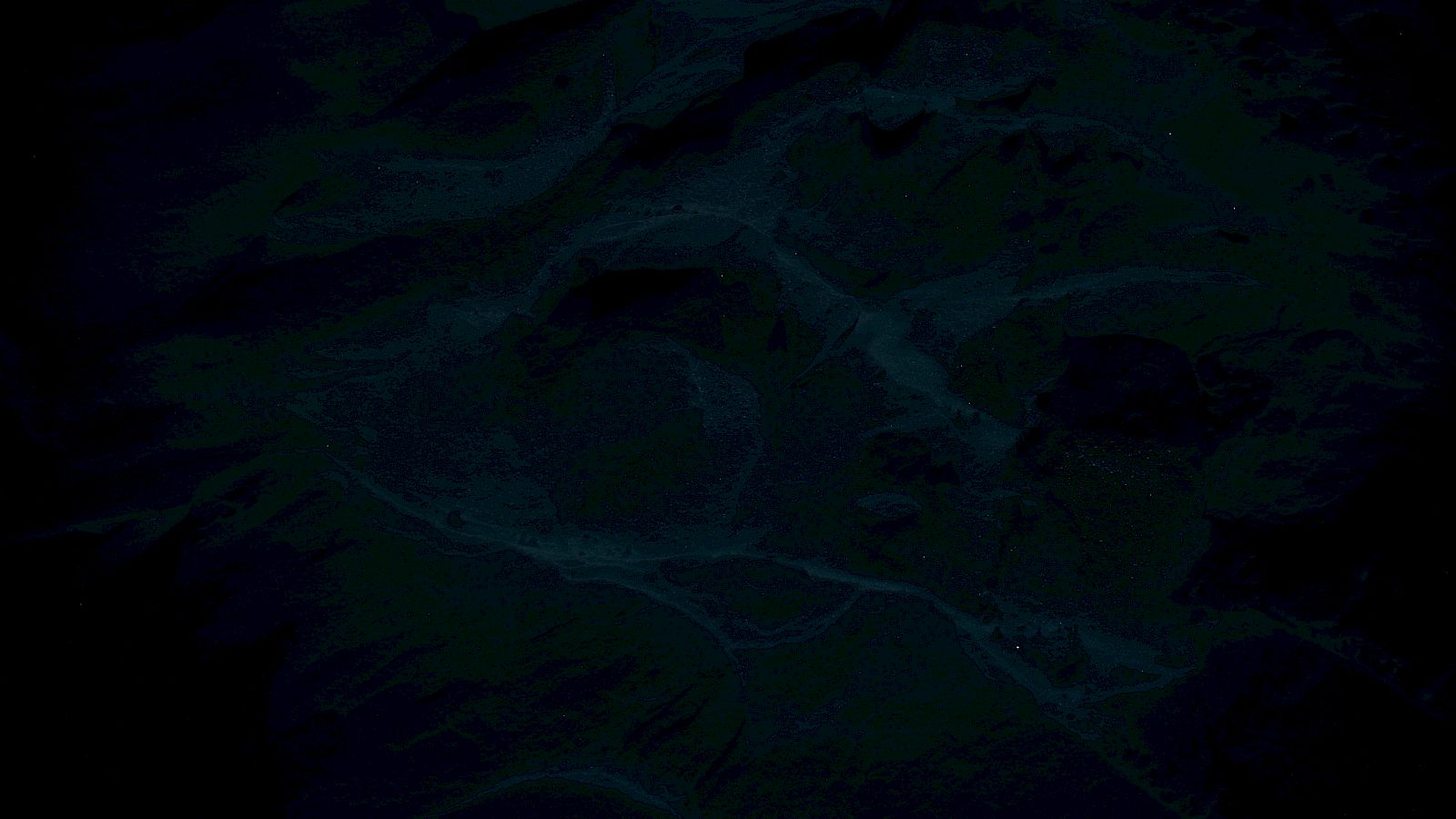 The image is very dark, showing faint outlines of textures, possibly resembling a landscape or abstract patterns.
